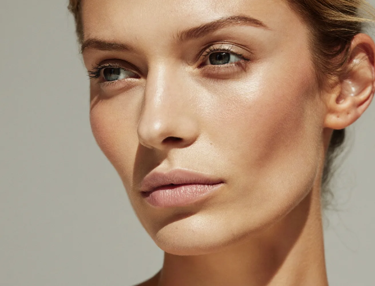 Retrato editorial de adulto con piel natural y luz diurna suave; contorno facial visible sin flechas ni dispositivos
